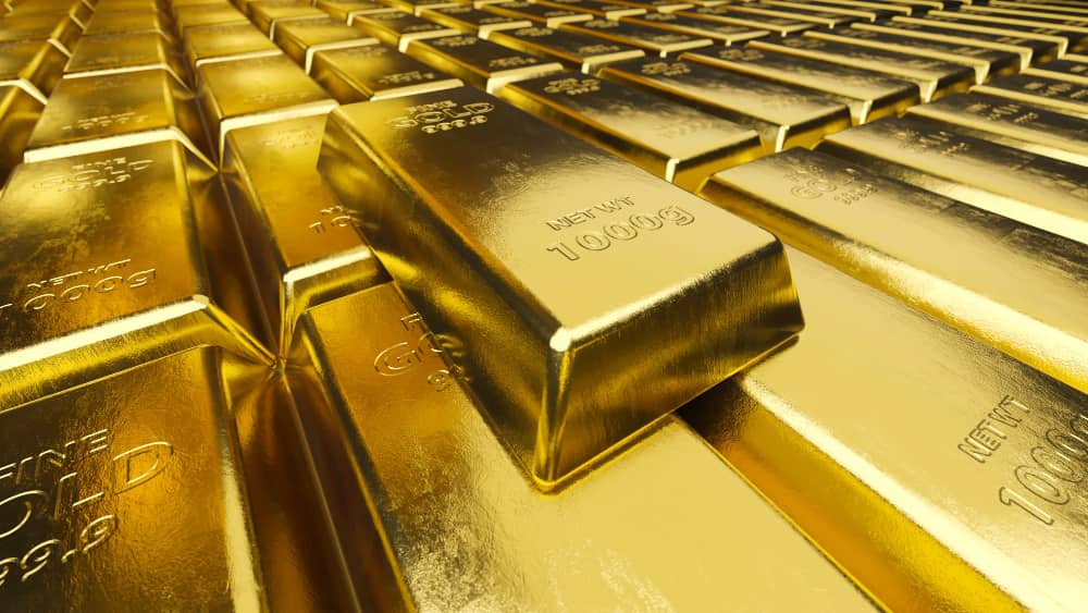 Alignement de lingots d'or de 1000g marqués "Fine Gold" pour retracer l'histoire de l'or physique